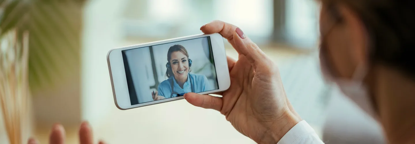 Patient holding phone talking to Nurse